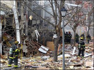 Firefighters work at the scene after an explosion at a townhouse complex  Tuesday in Ewing, N.J.