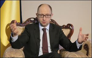 Ukrainian Prime Minister Arseniy Yatsenyuk talks with reporters during an interview with the Associated Press in Kiev, Ukraine, today.