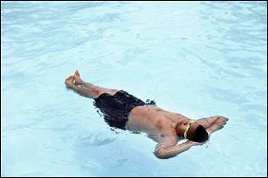 A swimmer floats on his back at Wilson Pool in Toledo in this 2013 photo. Wilson, along with five other pools and a splash pad, could be open again if funding sources are found.