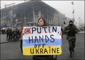A woman holds a poster against war at Kiev's Independence Square, in Ukraine, today.