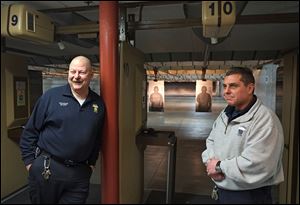 Retiring Toledo police officer Roger White, left, is retiring and being replaced as armorer by fellow officer Bill Michalski. They are at the city’s shooting range at the Scott Park District Station.