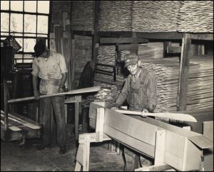Howard Brodbeck, left, and his father, Otto Brodbeck, pack wooden oars for shipment. Stryker Boat Oar Co. was a booming business  during the late 1800s and early 1900s. 