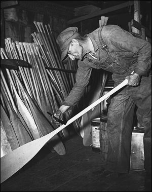 Otto Brodbeck  varnishes paddles in this 1949 photo.
