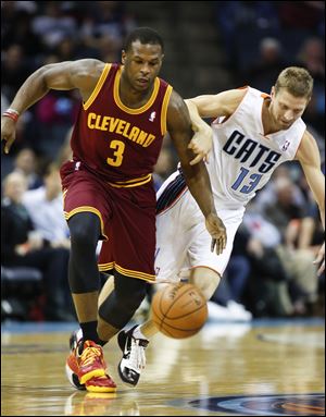 Charlotte Bobcats guard Luke Ridnour, right, fouls Cleveland Cavaliers guard Dion Waiters during the first half.
