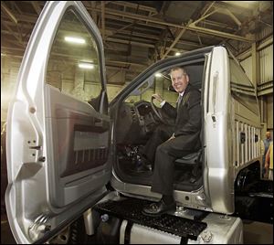 Joe Hinrichs, Ford’s president of the Americas, sits behind the wheel of a Ford F-750 medium-duty truck at the Ohio Assembly Plant on Friday in Avon Lake, Ohio, where one of two new truck models will be produced starting in 2015.