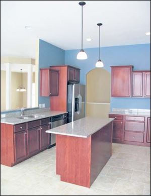 Warm cherry toned cabinets highlight open spaces. 