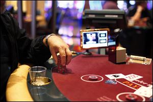 A patron stacks his chips while playing blackjack at Hollywood Casino Toledo.