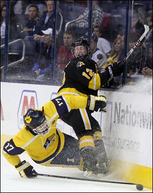 Northview's senior Cody Estrel (12) collides with St. Ignatius' junior Brady Wells (17) in pursuit of the puck during the first period.