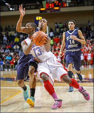 Bowsher’s Dajuan King is fouled by Anthony Glover, Jr. The Rebels will play Mansfield Senior in a regional semifinal on Wednesday.