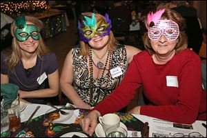Cher Harder, left, Julie Rittenhouse, center, and Kay Morgan, all of Sylvania, donned their masks at the Pardi Paws Mardi Gras Party to benefit the Toledo Animal Shelter.