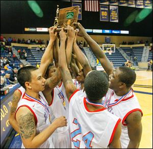 Bowsher High School players celebrate with their trophy after defeating St. John's Jesuit.