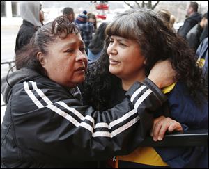 Ignacia Sanchez of Fremont, left, and Julia Sanchez of Woodville console each other during a vigil outside of the Last Call Bar for Julia Sanchez’s son, Ramiro ‘Ronnie’ Sanchez, 28, who was killed early Sunday while working at the bar in Fremont. He was one of three slain; another person was injured.