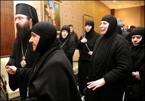 In this photo released by the Syrian official news agency SANA, a group of nuns who were freed after being held by rebels, greet church officials at the Syrian border town of Jdeidat Yabous, early Monday, March. 10, 2014.
