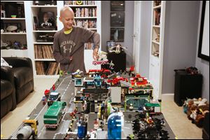 Gavin Boggs, 11, displays the Lego village he crafted in the basement of his family’s home in Rossford. Gavin was diagnosed last year with a rare form of bone cancer called localized Ewing’s sarcoma. 