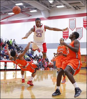 Bowsher’s Nate Allen goes flying as he is fouled by Mansfield Senior’s DeJorr Gibson, left. Allen led the Rebels with 22 points.