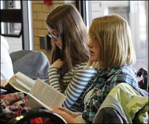 Napoleon Middle School eighth graders Abby Thomas, 14, and Madison Parker, also 14, read before the competition.