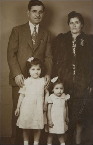 Manira Saide-Sallock, 5, front left, stands with her father, Mohammed Saide,  her mother, Hafiza, and sister, Salwah Igram, in the 1940s for a family portrait.