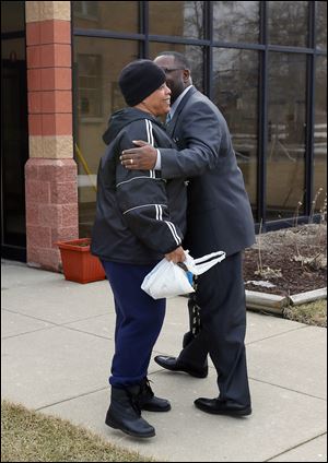 Pastor Arnold, right, greets Sister Lolita McCall while walking in between the church and the New Life Center.