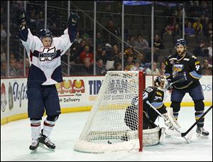 Kalamazoo’s Justin Taylor, left, celebrates after scoring a goal on Walleye goalie Hannu Toivonen on Friday.