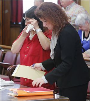 Defendant Candis Sherman with her attorney, Amber VanGunten, cries after she is sentenced in Fulton County to 10 years in prison for the attempted aggravated murder of her son, Logan, then 15.