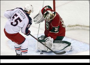 Minnesota Wild goalie Darcy Kuemper, right, stops a shot by Columbus Blue Jackets' Mark Letestu in the first period.