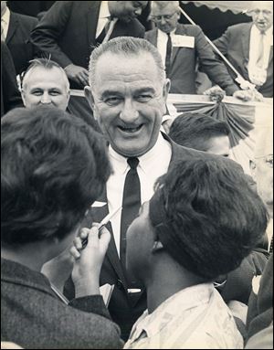 President Lyndon Baines Johnson greets a crowd as he campaigns in Toledo in 1963.
