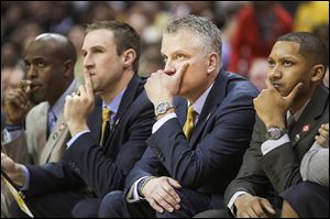 Toledo coach Tod Kowalczyk, second from right, and his staff watches near the end of the game. The Rockets trailed just 42-40 at half but were outscored 56-37 in the second half.