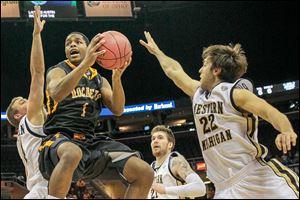 Toledo's Jonathan Williams, who had eight points, drives against WMU’s Austin Richie, right, in Saturday’s MAC championship.