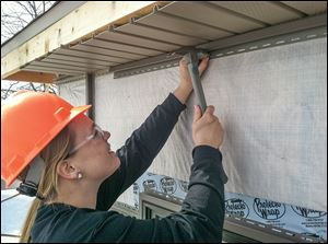 Cassie Kaptur works on the build for her Penta Career Center carpentry class. Students are constructing a 2,200-square-foot house for Gary Britten, a Perrysburg Township trustee.