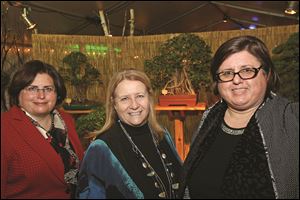 Committee members Elizabeth Foley, foundation board member, left, Ann Sanford, center, and Susan Conda attend the Once Upon a Vine event in the Spring Alive floral exhibit at the Toledo Zoo.