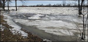 Chunks of ice clog the Maumee River in Waterville. After cresting Sunday night, the water level had receded nearly three feet by midafternoon Monday.