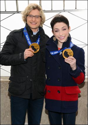 Olympic gold medalist ice dancers Meryl Davis and Charlie White, left, at the Empire State Building in New York. Theyll compete against, instead of with, each other on Dancing With The Stars.