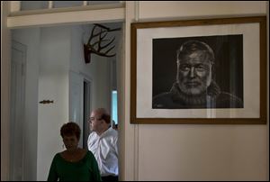 U.S. Congressman Jim McGovern, right, takes a tour inside Ernest Hemingway's former home Monday near Havana, Cuba.