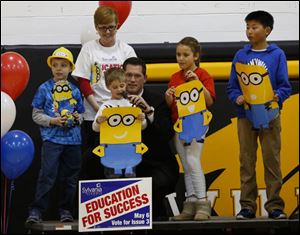 Highland Elementary student Lucas Wholehan, 6, reads a statement during a pep rally at Northview High School. Helping him is his principal Paul Gibbs. Others from left are Noah Andres, Lucas Wholehan, Livia Ford and Jae Choi. Adult in back is Highland Parent Org treasurer Kelli Andres.