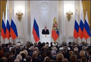 Russian President Vladimir Putin addresses the Federal Assembly in the Kremlin in Moscow, today.