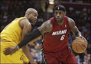 Miami Heat's LeBron James, right, drives around Cleveland Cavaliers' Jarrett Jack during the second quarter.