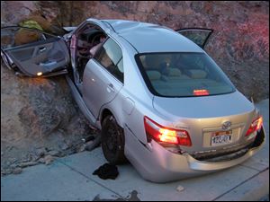  In this  2010  photo released by the Utah Highway Patrol, a Toyota Camry is shown after it crashed as it exited I- 80 in Wendover, Utah. Police suspect problems with the Camry's accelerator or floor mat caused the crash that left two people dead and two others injured. 
