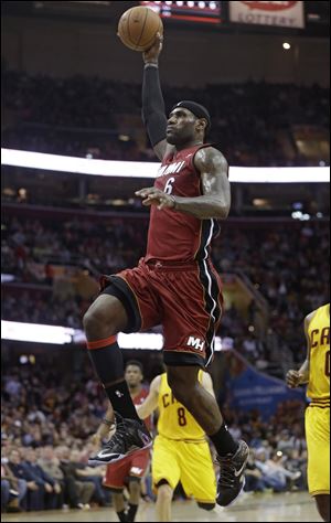 Miami Heat's LeBron James (6) jumps to the basket against the Cleveland Cavaliers during the first quarter.