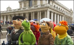 Muppet characters, from left, Gonzo, Miss Piggy, Kermit, Floyd, Walter, and Scooter in a scene from ‘Muppets Most Wanted.’