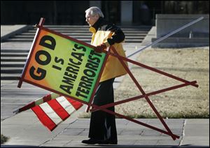 The Rev. Fred Phelps Sr. prepares to protest outside the Kansas Statehouse in Topeka, Kan., in July, 2007.