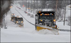 A line of trucks with plows head south on Route 202 between Dilworthtown Road and Route 1 in Birmingham Township, Pa. in February.