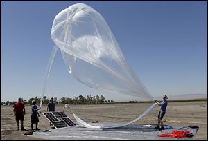 A Google team launches a high-altitude balloon carrying electronic testing equipment into the skies above Dos Palos, Calif.