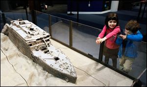 Nina Rubinstein, 5, and her brother Jake Rubinstein, 3, of New York look at a replica of the Titanic on display at the Titanic Artifact Exhibition at Imagination Station.