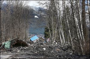 A demolished house sits in the mud on Highway 530, the day after a giant mudslide hurtled into homes, trees, and anything else in its way near Oso, Wash. 