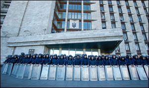 Ukrainian police block a regional administrative building during a pro-Russian rally in Donetsk. About 5,000 demonstrated in favor of holding a referendum on secession and absorption into Russia, similar to Crimea’s. (AP Photo/Sergei Grits)