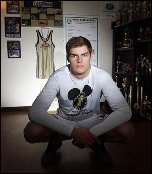 Perrysburg High School wrestler Rocco Caywood, 18, at his home, has committed to attending the U.S. Military Academy. and spending at least five years on active military duty after graduation. The focus that goes with being a cadet at the academy appealed to him most.