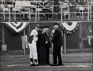 Mud Hens manager Frank Verdi meets with umpires before the opening day game in 1965 at the Lucas County Recreation Center.