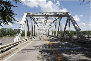 A new bridge immediately next to the existing structure or one angling across the Maumee River toward Farnsworth Road are two of three options the Ohio Department of Transportation is considering for replacing the Waterville Bridge.