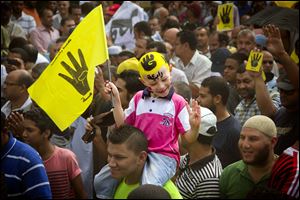 A young Egyptian boy participates in a demonstration by supporters of ousted President Mohammed Morsi in the Maadi district of Cairo, Egypt. 