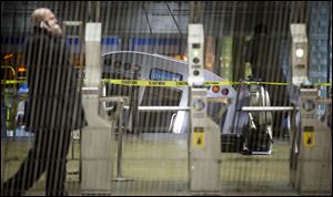 A derailed Chicago Transit Authority train car rests on an escalator at the O'Hare Airport station early Monday in Chicago. More than 30 people were injured after the eight-car train plowed across a platform and scaled the escalator at the underground station. 